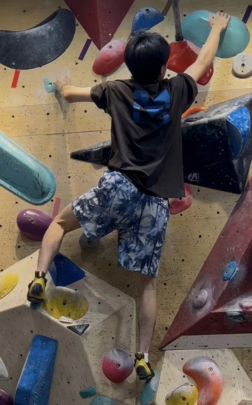 Kevin climbing on an indoor bouldering wall